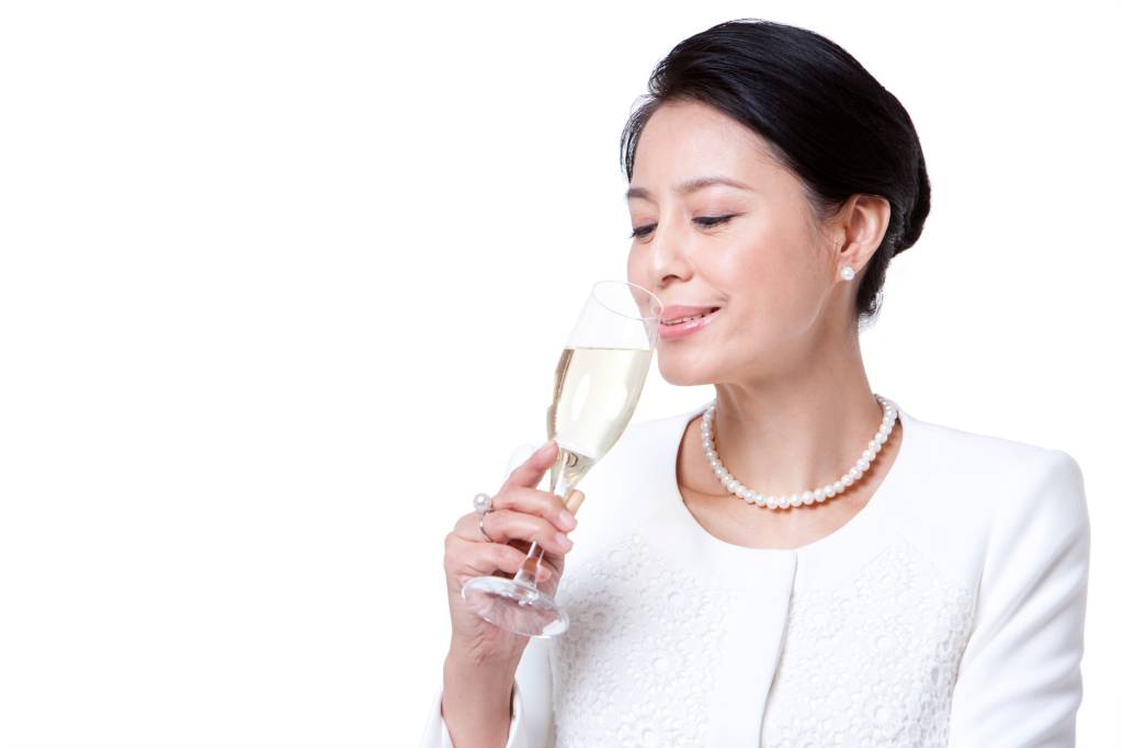 Elegant mature woman drinking champagne